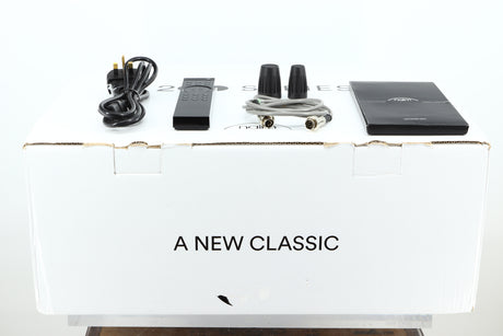Box of a used Naim NSS333 Streamer showing mains cable, manual, remote, SNAIC, and burndy plugs