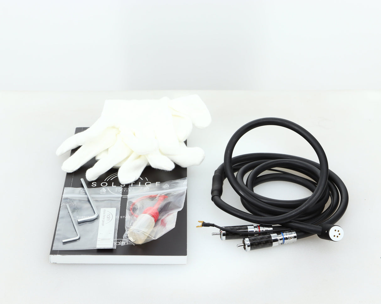 Accessories for a Naim Solstice Special Edition Turntable in a black finish showing Gloves, Tonearm Cable, 2x Allen Keys, Oil, Stylus Force Gauge and Manual