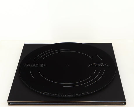 Top of a used Naim Dust Protector and Manual in a black finish
