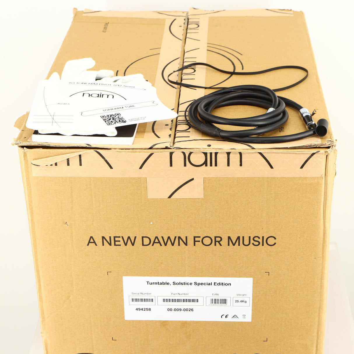 Box for a used Naim Solstice Turntable Package in a black finish showing 2x Gloves, Tonearm Cable and Manual