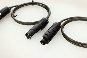 Close up of used Naim Super Lumina 4PIN DIN-XLR Interconnect Cables in a black finish showing connectors