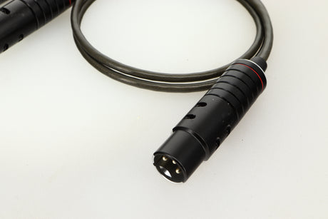 Close up of used Naim Super Lumina 4PIN DIN-XLR Interconnect Cables in a black finish showing connector