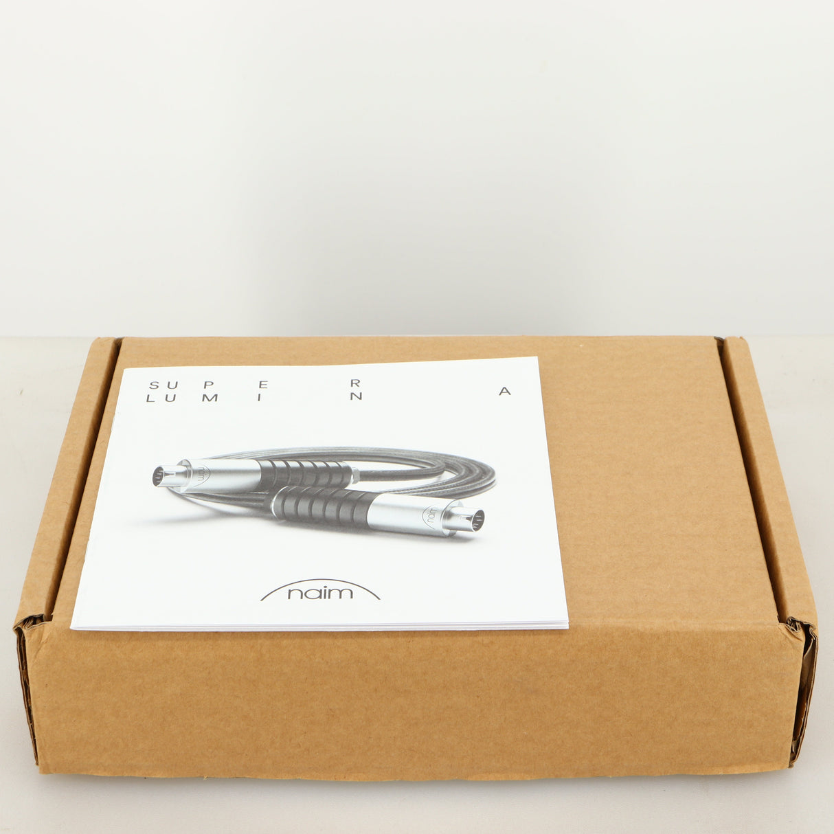 Outer box for used Naim Super Lumina 4PIN DIN-XLR Interconnect Cables in a black finish showing Manual