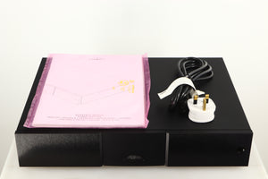Top of a used Naim Supercap DR Power Supply in a black finish showing Manual and Mains Cable