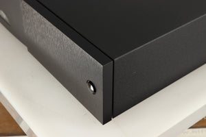 Front right corner of a used Naim Supercap DR Power Supply in a black finish