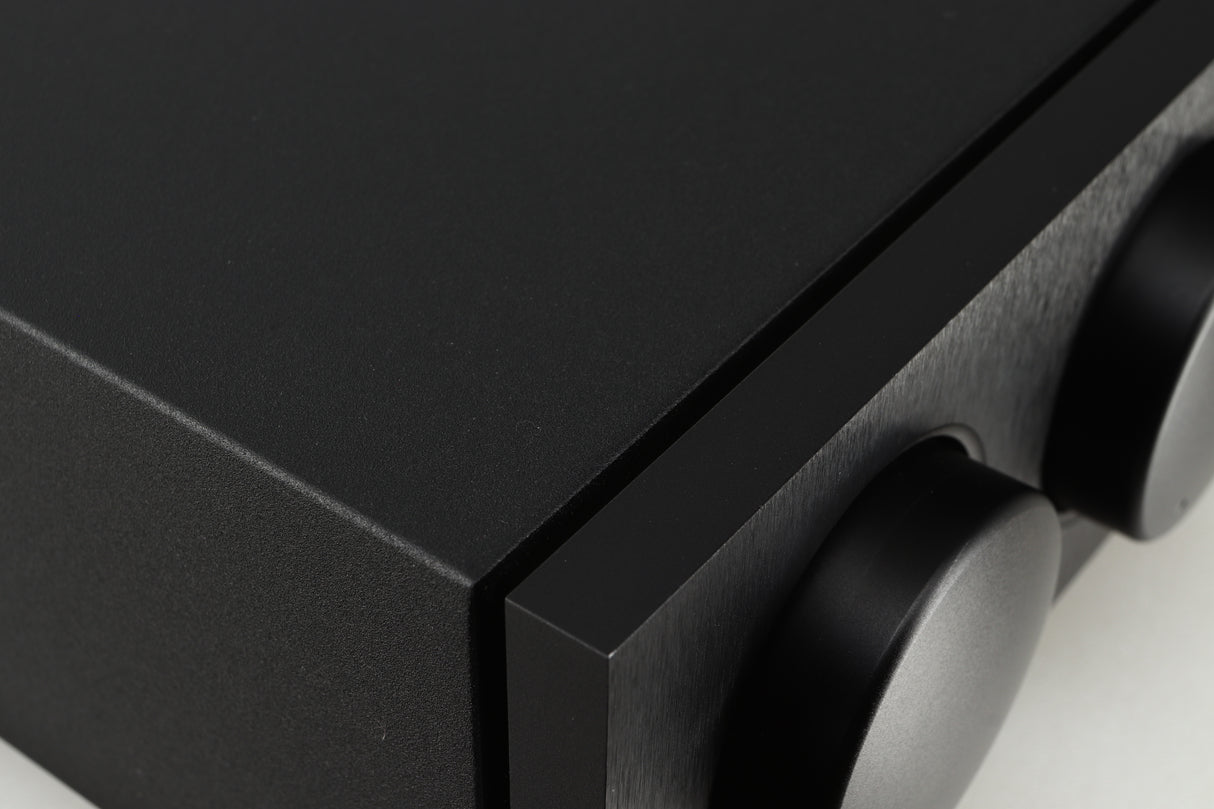 Close up of a used Naim Supernait 2 Integrated Amplifier in a black finish showing a light scratch on volume knob