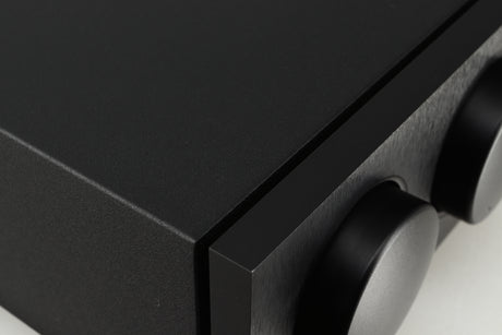 Close up of a used Naim Supernait 2 Integrated Amplifier in a black finish showing a light scratch on volume knob