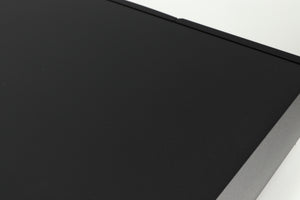 Close up of a used Naim Supernait 2 Integrated Amplifier in a black finish showing a dark scratch on top