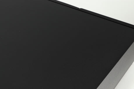 Close up of a used Naim Supernait 2 Integrated Amplifier in a black finish showing a dark scratch on top