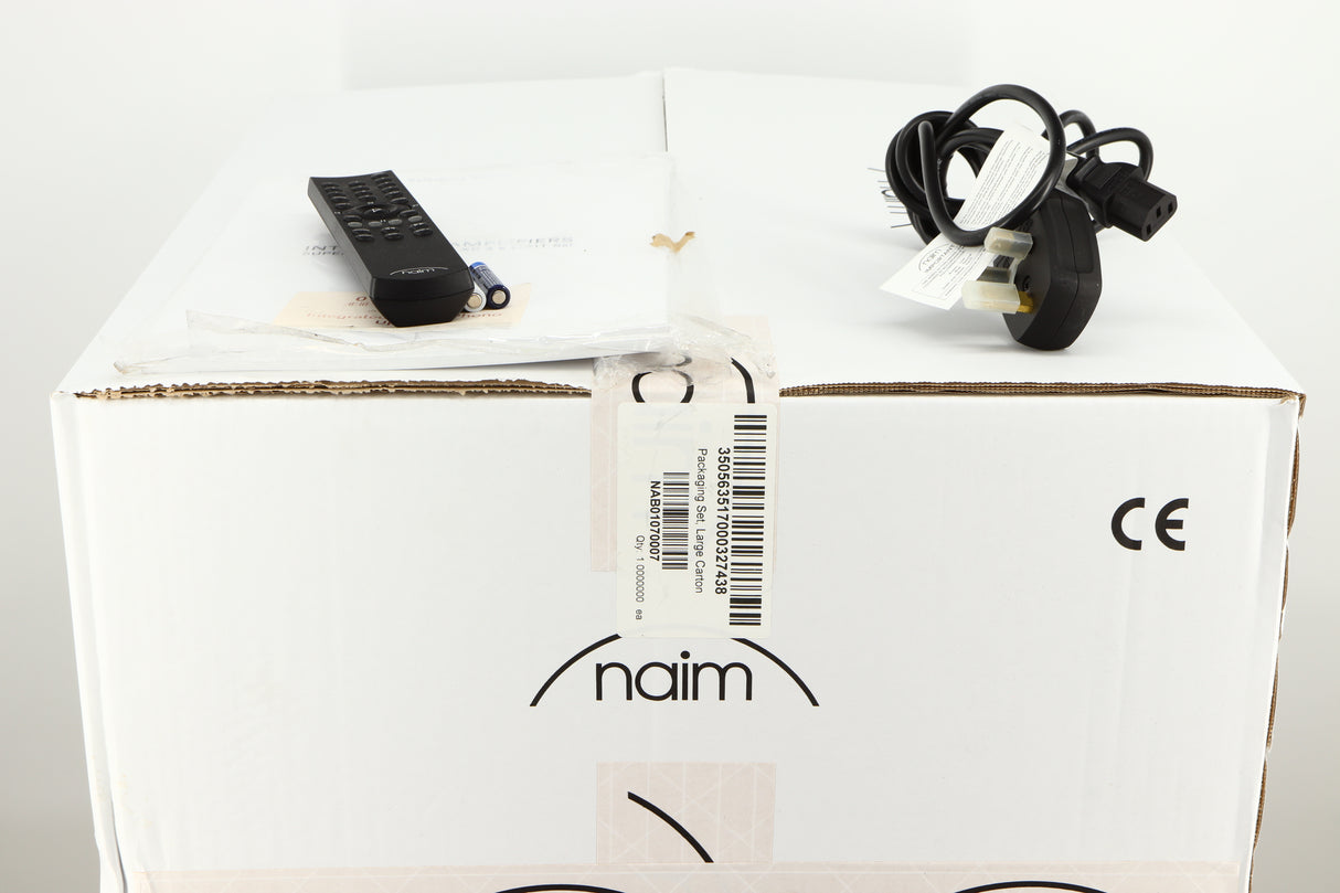 Box for a used Naim Supernait 3 Integrated Amplifier in a black finish showing Manual, Remote, 3x Batteries and Mains Cable