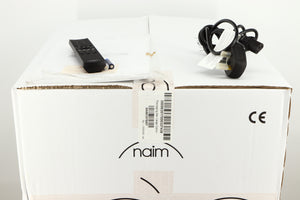 Box for a used Naim Supernait 3 Integrated Amplifier in a black finish showing Manual, Remote, 3x Batteries and Mains Cable