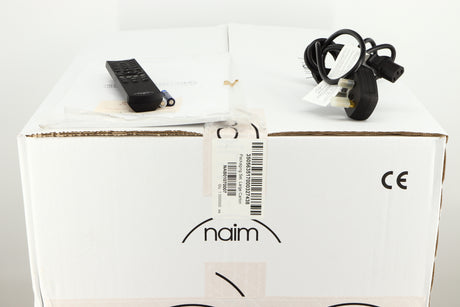 Box for a used Naim Supernait 3 Integrated Amplifier in a black finish showing Manual, Remote, 3x Batteries and Mains Cable