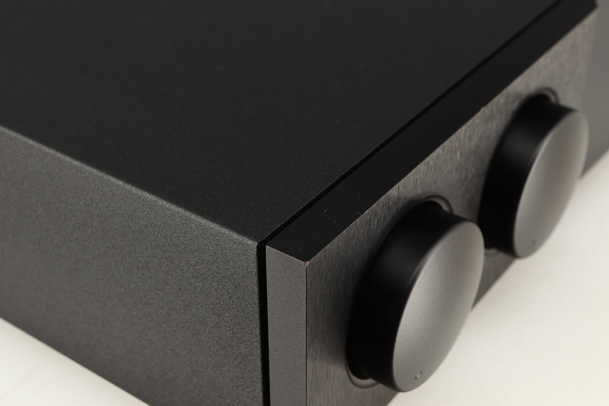 Close up of a used Naim Supernait 3 Integrated Amplifier in a black finish showing small chip on front left corner 