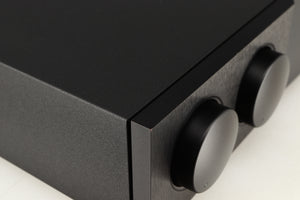 Close up of a used Naim Supernait 3 Integrated Amplifier in a black finish showing small chip on front left corner 