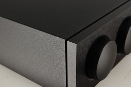 Close up of a used Naim Supernait 3 Integrated Amplifier in a black finish showing very light scratch on left side