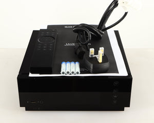 Top of a used Naim Uniti Atom HDMI Integrated System in a black finish showing Mains Cable, Manual, Remote and Batteries