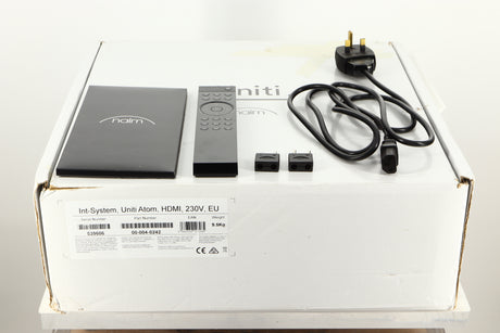 Box of a used Naim Uniti Atom HDMI Integrated System with mains cable, manual, remote, and speaker plugs 