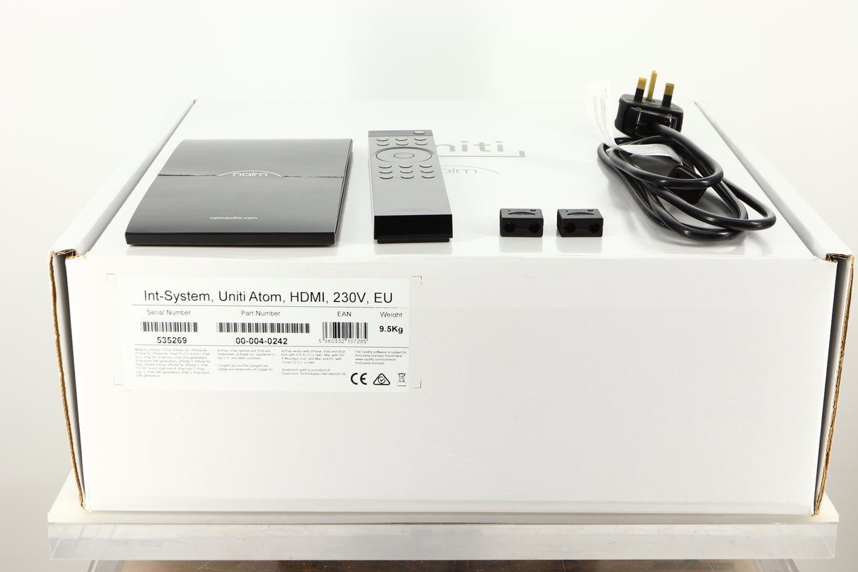 Box of a used Naim Uniti Atom HDMI Integrated System with mains cable, manual, remote, and speaker plugs