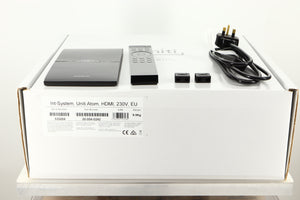 Box of a used Naim Uniti Atom HDMI Integrated System with mains cable, manual, remote, and speaker plugs