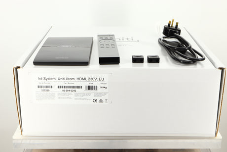 Box of a used Naim Uniti Atom HDMI Integrated System with mains cable, manual, remote, and speaker plugs