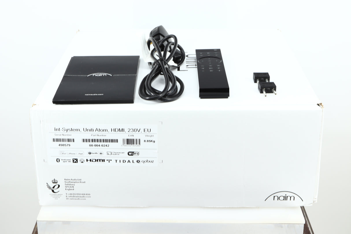 Box of a used Naim Uniti Atom HDMI Streaming Amplifier showing mains cable, manual, remote, and speaker plugs