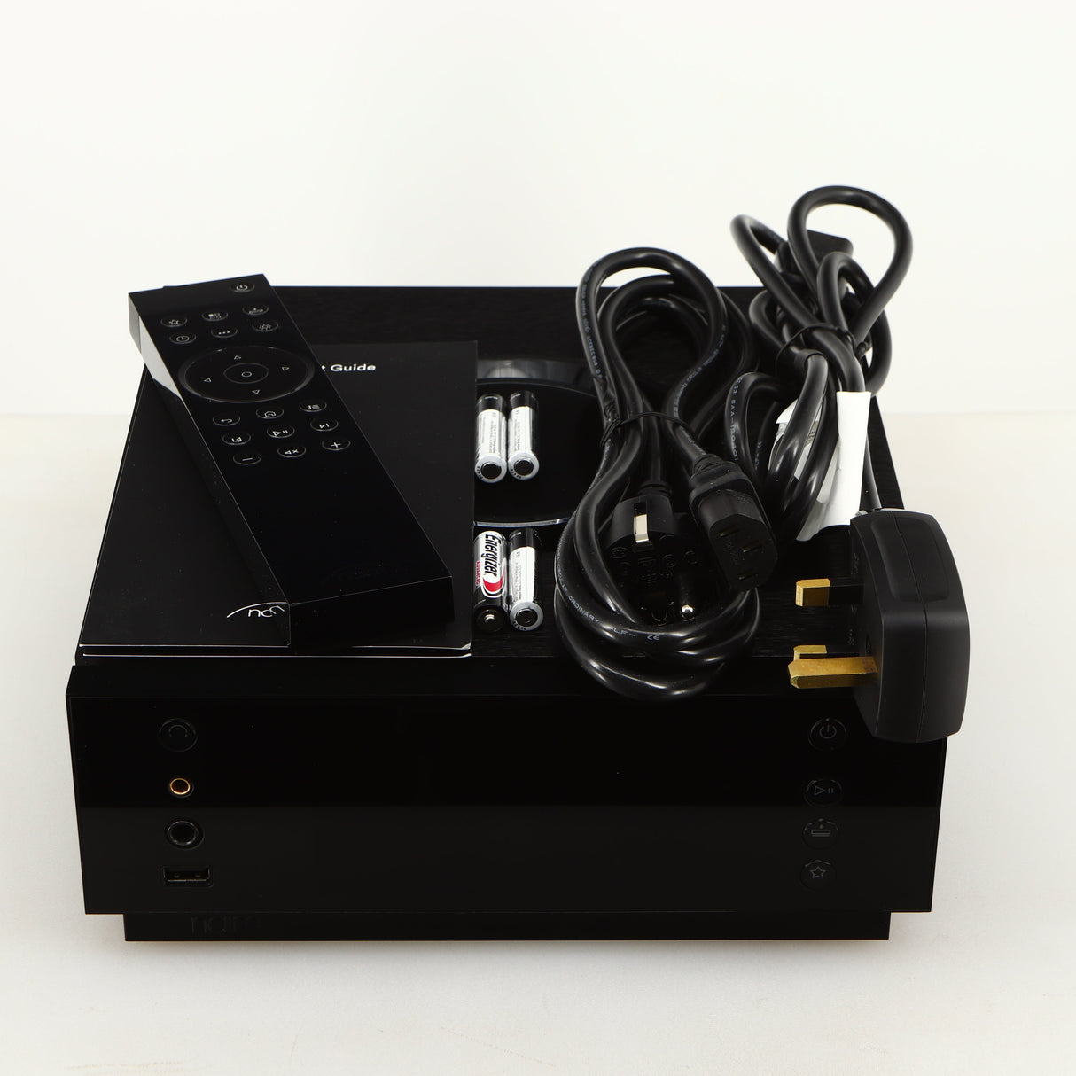 Top of a used Naim Uniti Atom Headphone Edition Streaming Amplifier in a black finish showing Remote, 4x Batteries, Schuko Cable, mains Cable and Manual