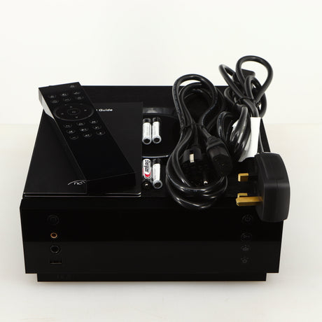 Top of a used Naim Uniti Atom Headphone Edition Streaming Amplifier in a black finish showing Remote, 4x Batteries, Schuko Cable, mains Cable and Manual