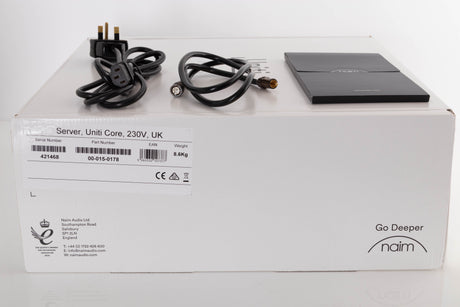 Box of a used Naim Uniti Core Server with mains cable, manual, and BNC-RCA cable