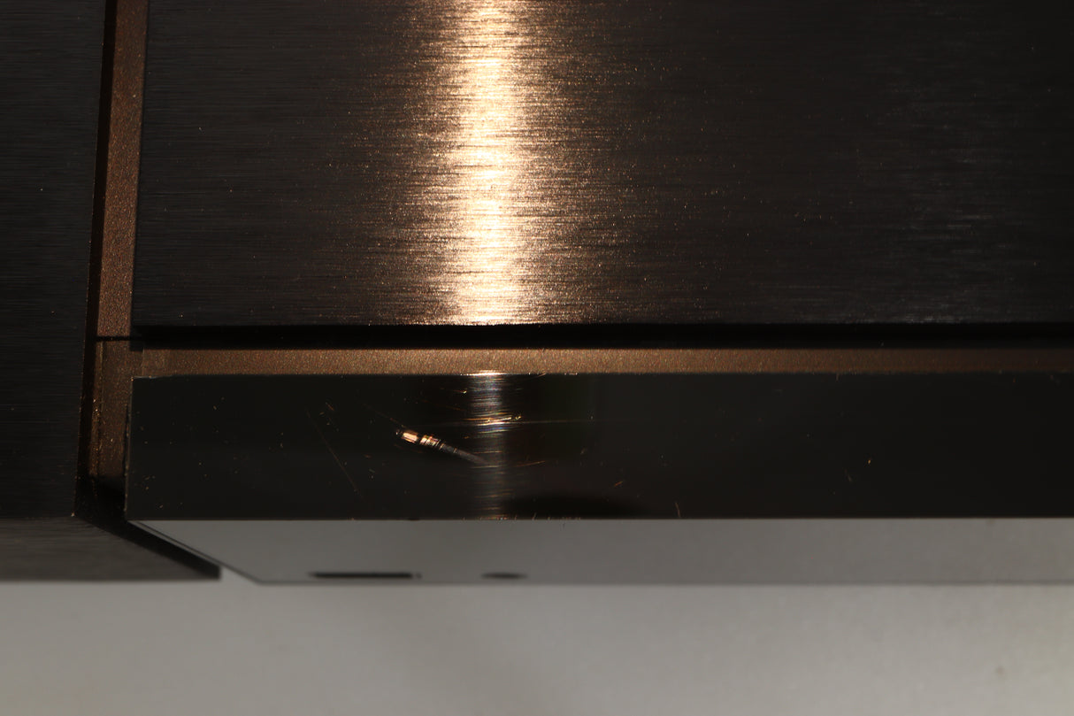 Close up view of a used Naim Uniti Nova Integrated Digital Music System showing scratching on the top front edge