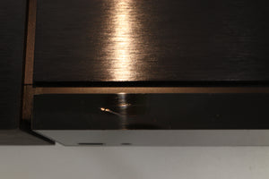 Close up view of a used Naim Uniti Nova Integrated Digital Music System showing scratching on the top front edge