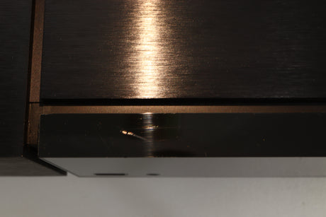 Close up view of a used Naim Uniti Nova Integrated Digital Music System showing scratching on the top front edge