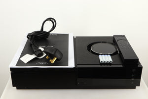 Top of a used Naim Uniti Star Integrated Music System in a black finish showing Manual, Mains Cable, Batteries and Remote