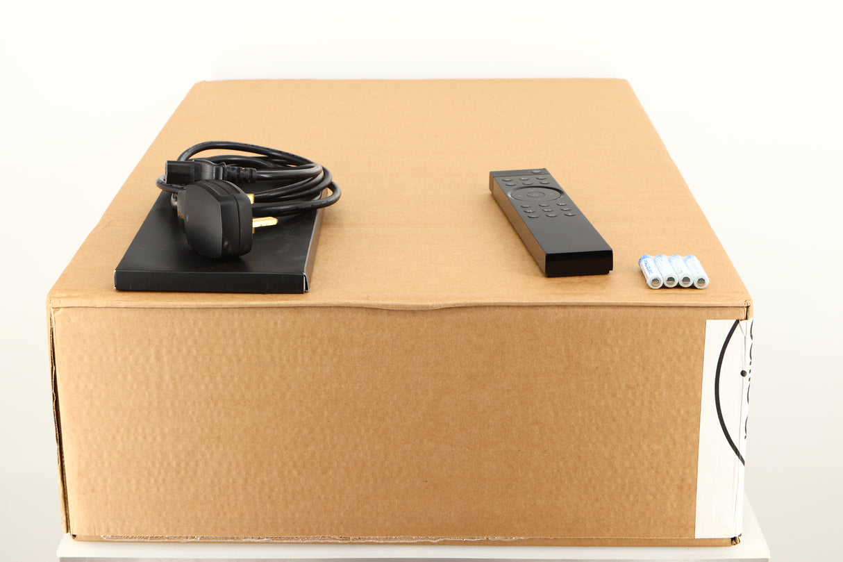 Box for a used Naim Uniti Star Integrated Music System in a black finish showing Manual, Mains Cable, Remote and 4x Batteries