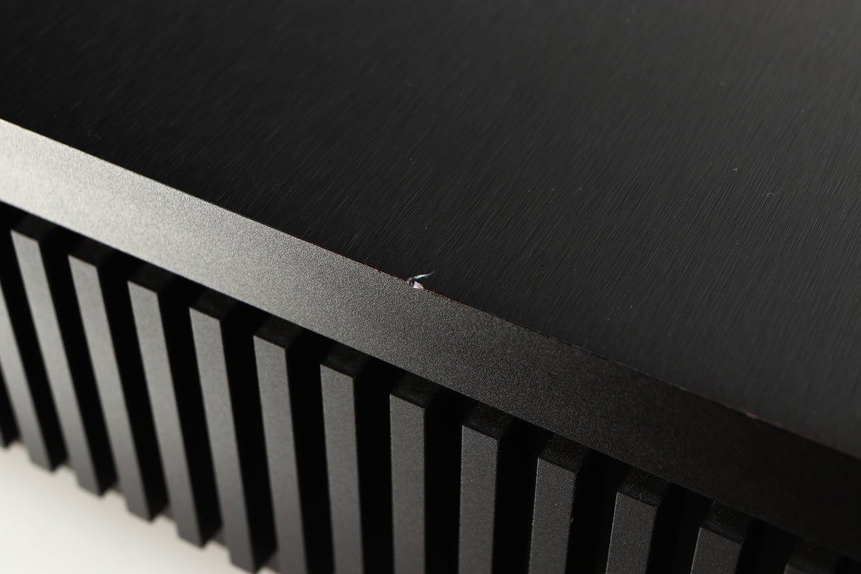Close up of a used Naim Uniti Star Integrated Music System in a black finish showing small chip on left edge
