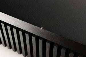 Close up of a used Naim Uniti Star Integrated Music System in a black finish showing small chip on left edge