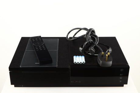 Top of a used Naim Uniti Star Streaming System in a black finish showing Remote, Manual, Mains Cable and 4x Batteries