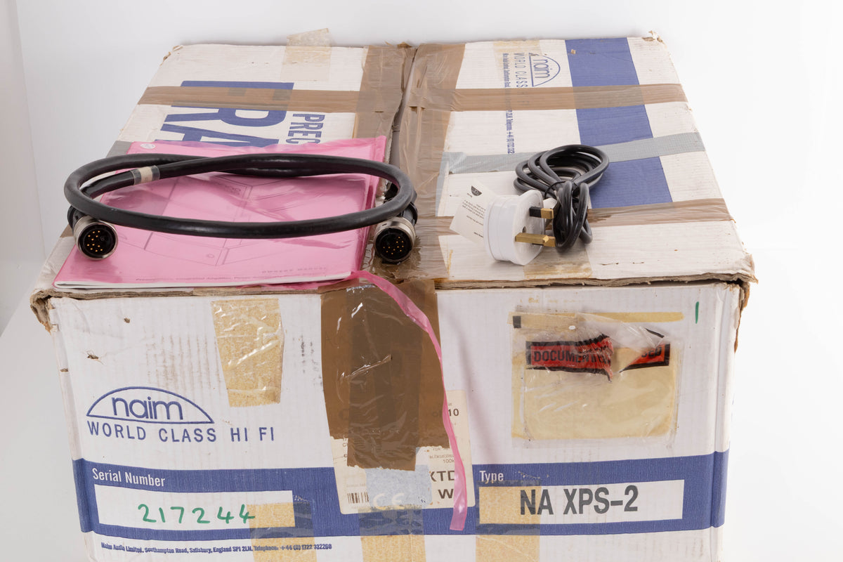 Box for a used Naim XPS-2 Power Supply in a Black finish showing Manual, Burndy Cable and Mains Cable