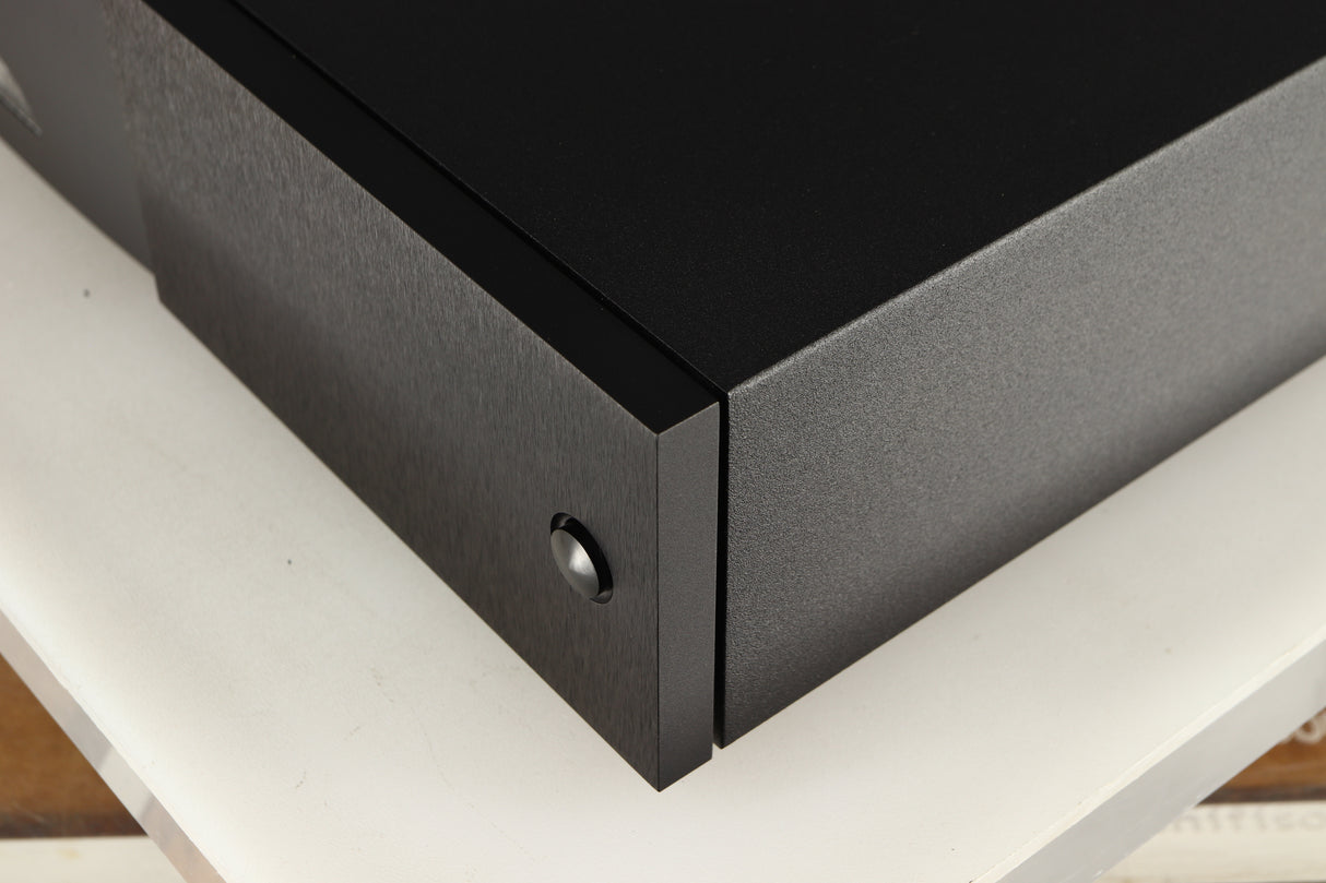Front right corner of a used Naim XPS DR Power Supply in a black finish