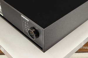 Rear left corner of a used Naim XPS DR Power Supply in a black finish