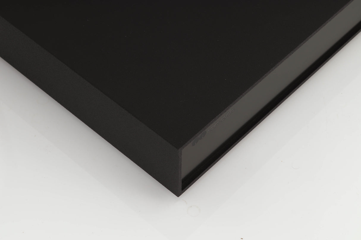Front left corner of a used Naim XPS Power Supply in a black finish