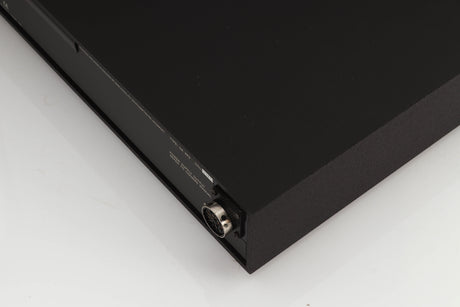 Rear left corner of a used Naim XPS Power Supply in a black finish