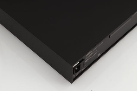 Rear right corner of a used Naim XPS Power Supply in a black finish