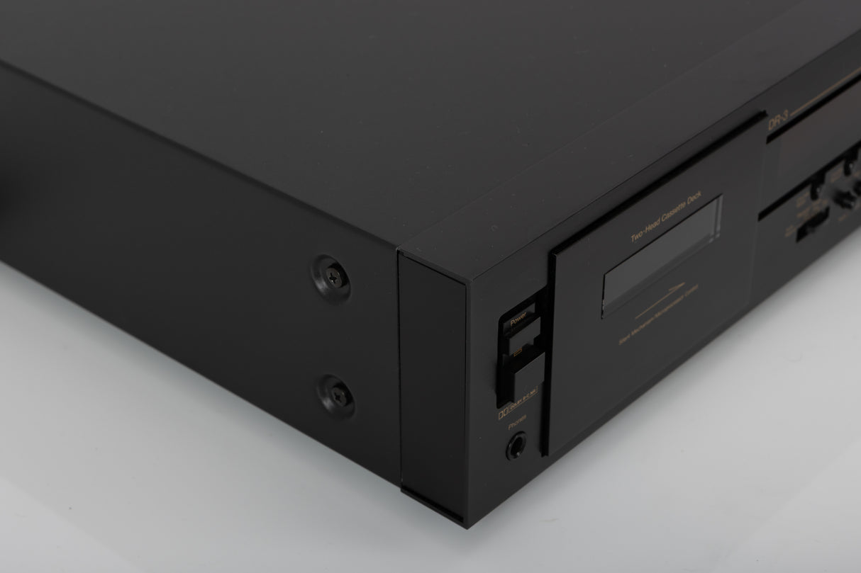 Front left corner of a used Nakamichi DR-3 Cassette Deck in a black finish