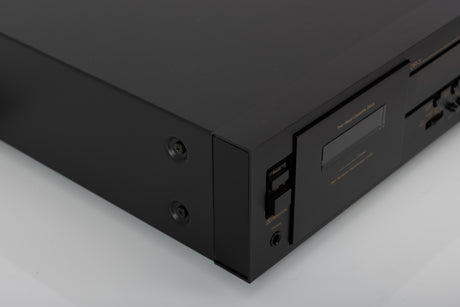 Front left corner of a used Nakamichi DR-3 Cassette Deck in a black finish