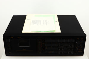 Top of a used Nakamichi Dragon Cassette Deck in a black finish showing Manual