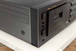 Front left corner of a used Nakamichi Dragon Cassette Deck in a black finish