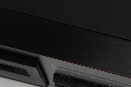 Close up of a used Nakamichi ZX-7 Cassette Deck in a black finish showing scratches on top