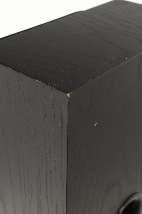 Close up view of a used NEAT Acoustics Iota Alpha Floorstanding Speaker in Black Oak finish showing damage to the paint on the back corner