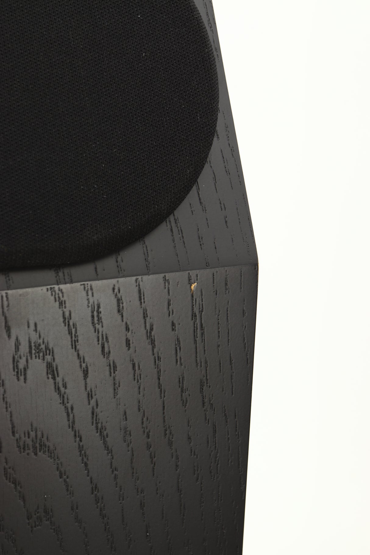 Close up view of a used NEAT Acoustics Iota Alpha Floorstanding Speaker in Black Oak finish showing a small surface chip on the front of the speaker