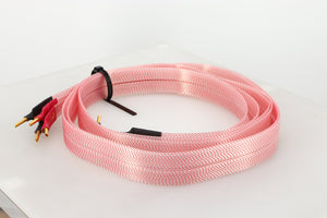 Front right angle of a used Nordost Heimdall 2 Speaker Cables 2.0m Pair in a pink finish